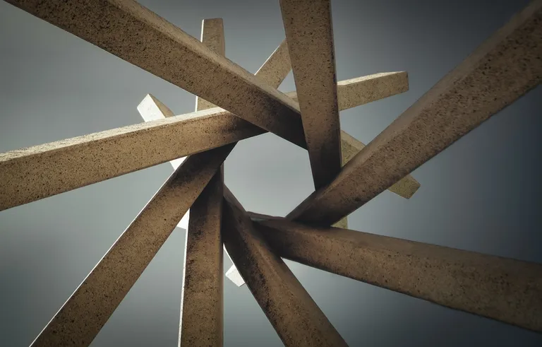 A photo by Todd Trapani of a modern art sculpture made of interlocking concrete beams