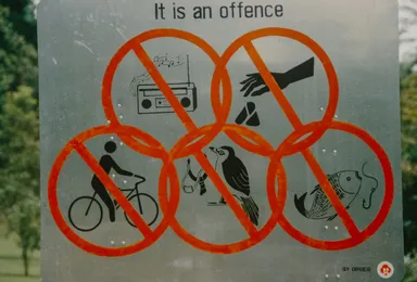 A sign labelled "It is an offence" with lots of icons of things that are forbidden including a stereo, cycling and more cryptic things like a catapult with a bird