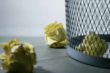 Some scrunched-up balls of notepaper in a bin