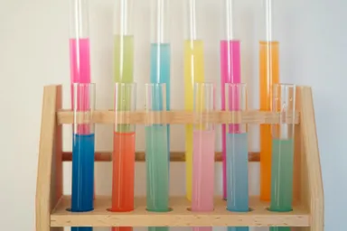 A photo by Vedrana Filipović of a rake of test tubes containing coloured liquids.