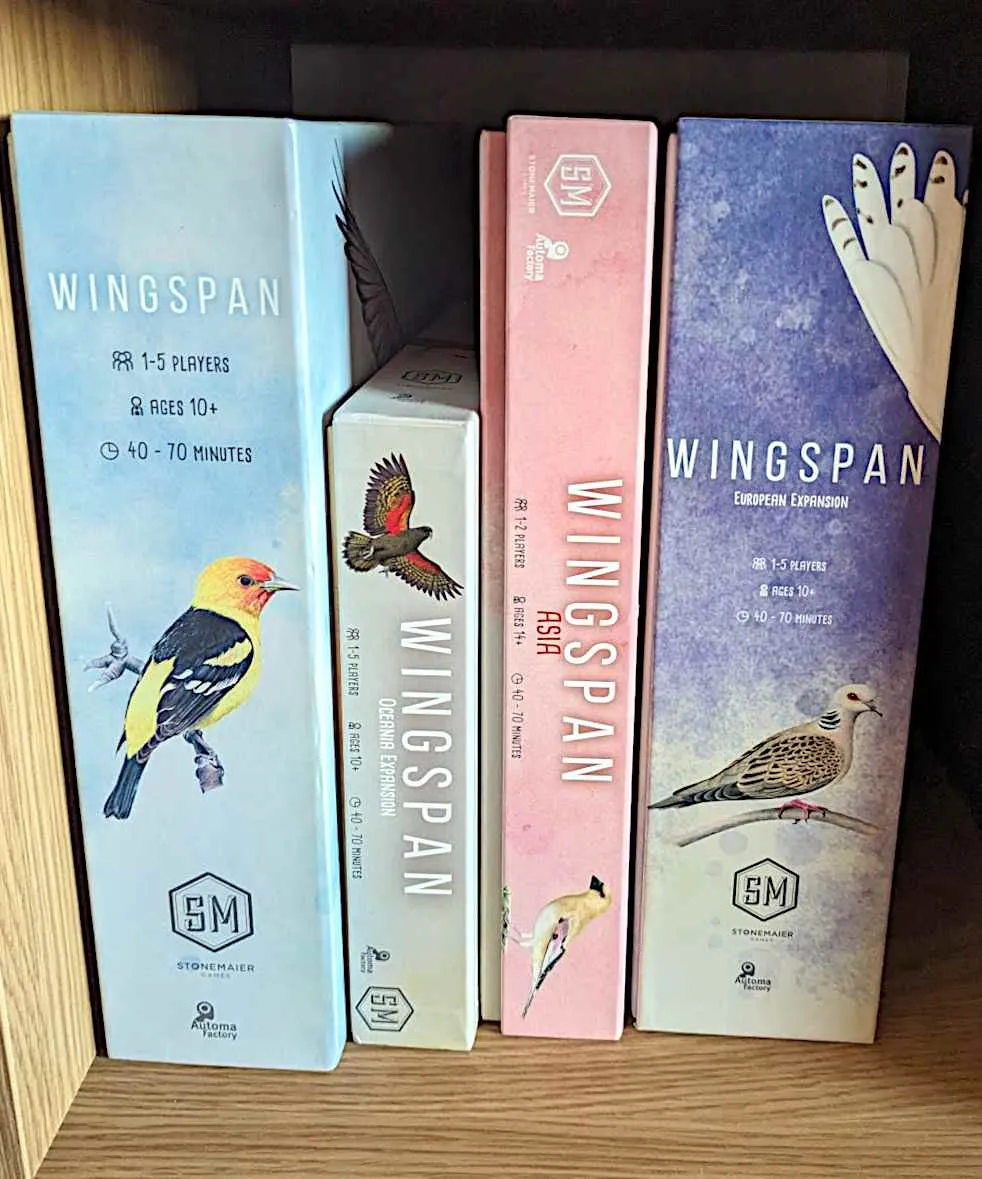 Shelf with four "Wingspan" game boxes on it